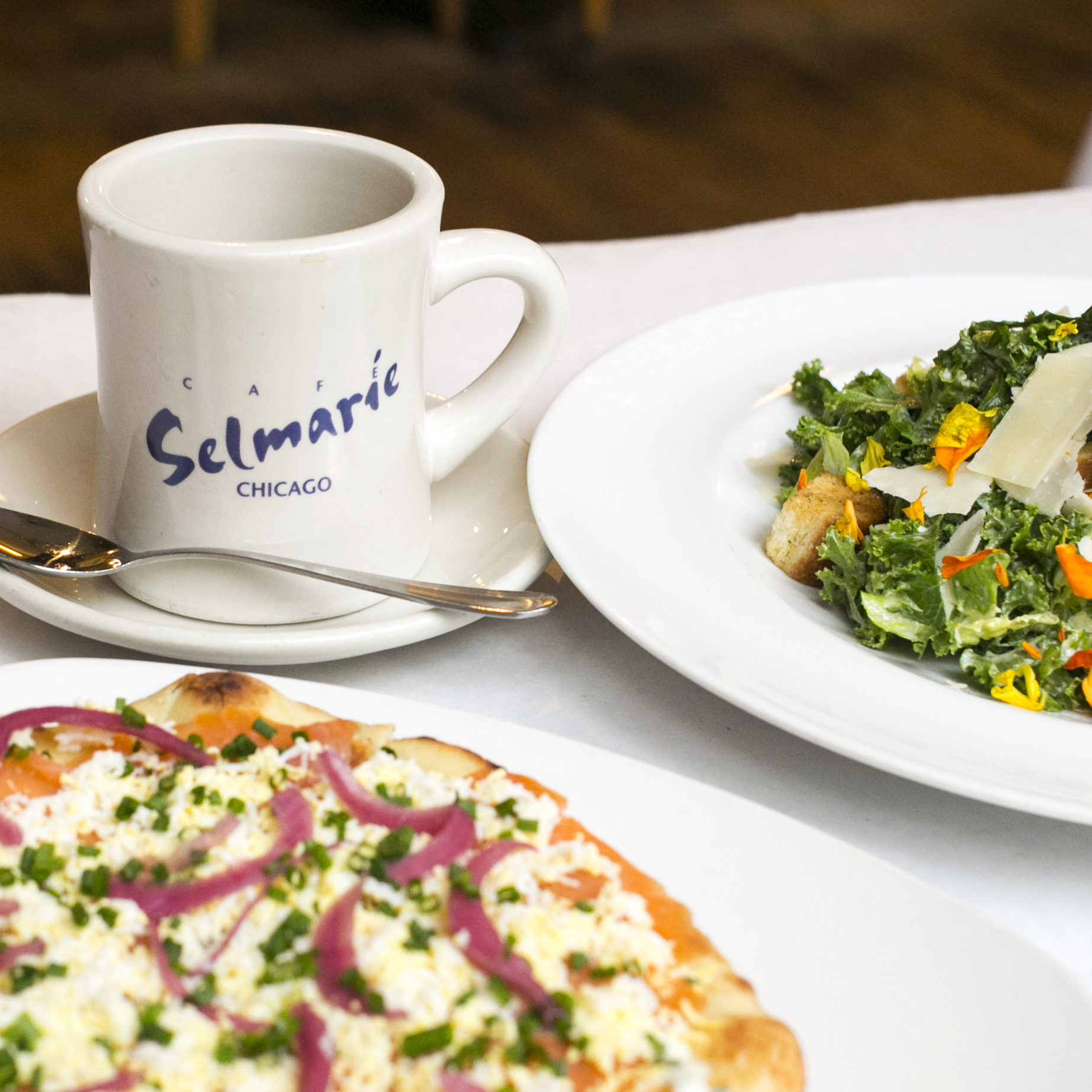 Salmon flatbread, salad, and coffee cup at Cafe Selmarie.