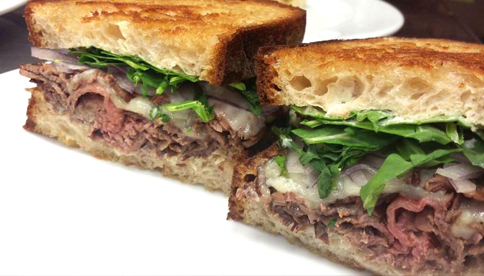 Roast beef, arugula, red onions, and provolone on griddled sourdough bread.