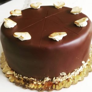 Spanish almond torte, glazed with dark chocolate and decorated with marzipan hearts