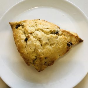 Overhead view of white plate with currant cream scone