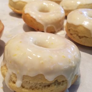 Tray of baked lemon donuts covered with lemon icing